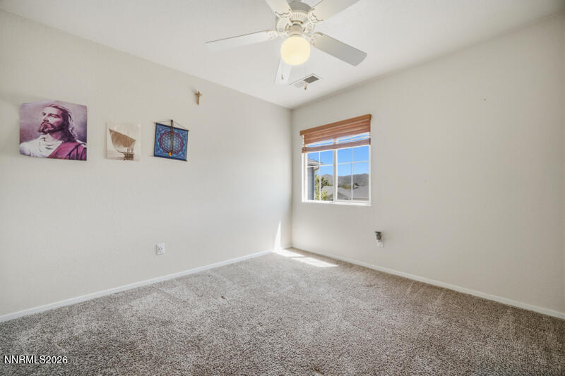 7873 Welsh Drive Reno, NV 89506 - Photo 21 of 34 a view of an empty room with window and chandelier fan