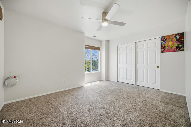 7873 Welsh Drive Reno, NV 89506 - Photo 23 of 34 an empty room with a ceiling fan and a window