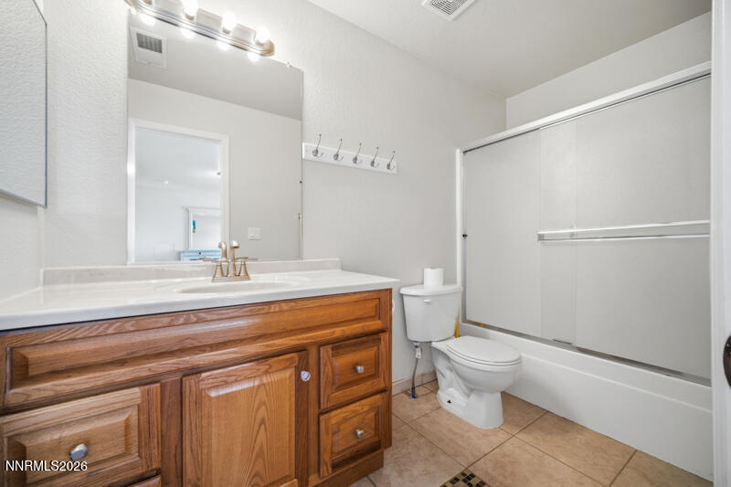 7873 Welsh Drive Reno, NV 89506 - Photo 28 of 34 a bathroom with a sink a toilet a mirror and shower