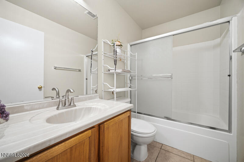 7873 Welsh Drive Reno, NV 89506 - Photo 29 of 34 a bathroom with a granite countertop sink toilet and shower