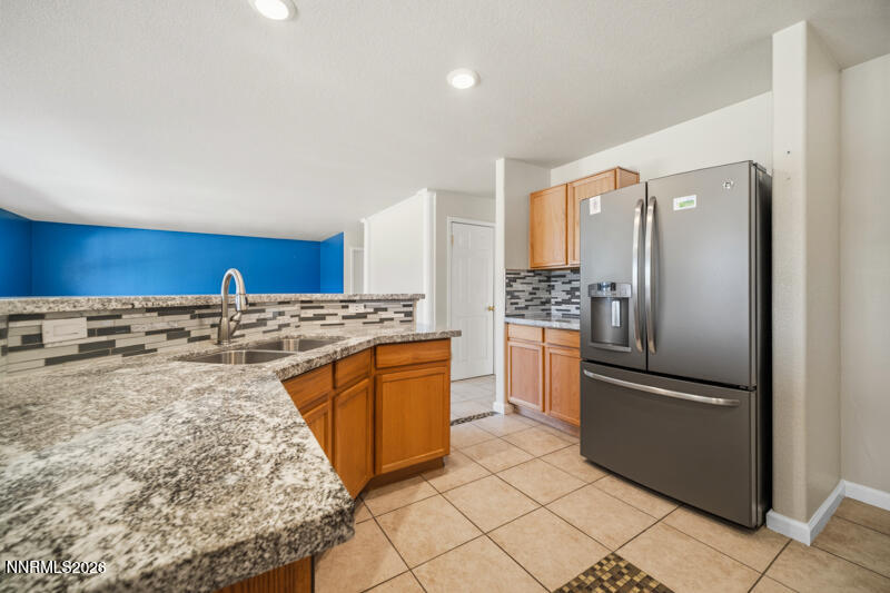 7873 Welsh Drive Reno, NV 89506 - Photo 8 of 34 a kitchen with stainless steel appliances granite countertop a refrigerator and a stove top oven