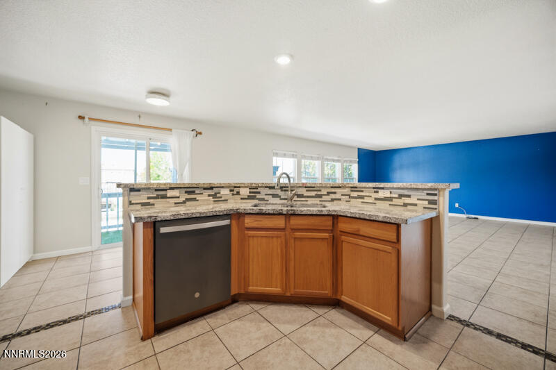 7873 Welsh Drive Reno, NV 89506 - Photo 9 of 34 a kitchen with stainless steel appliances granite countertop a sink and a stove