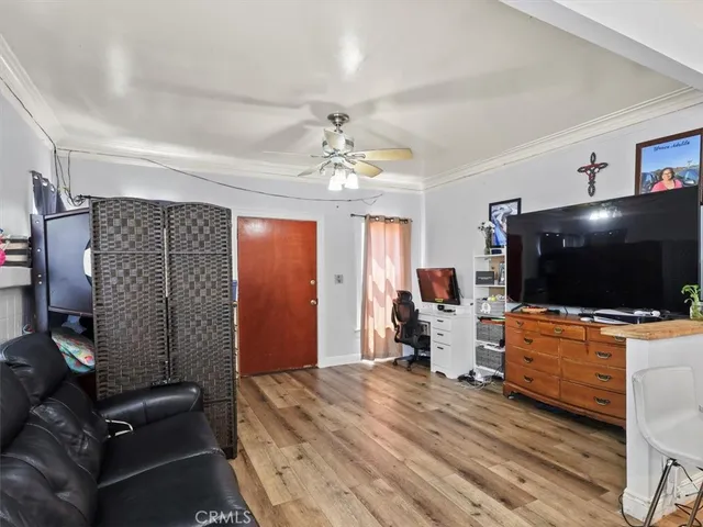 a bedroom with furniture and a flat screen tv