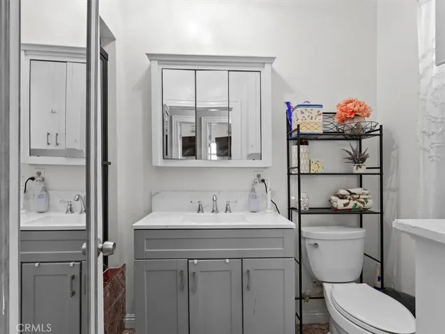 a bathroom with a toilet sink and mirror