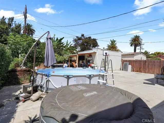 a view of a house with backyard and sitting area
