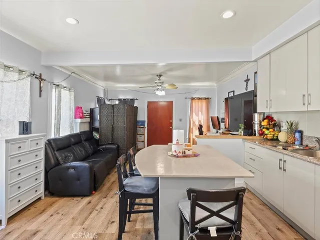 a living room with stainless steel appliances kitchen island granite countertop furniture and a kitchen view