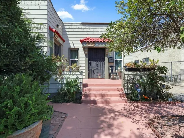 a view of a house with potted plants