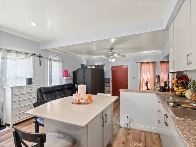 a large kitchen with a table and chairs