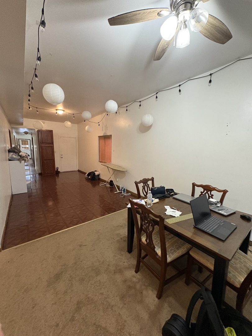 8729 South Commercial Avenue Chicago, IL 60617 - Photo 2 of 17 a workspace with furniture and chandelier