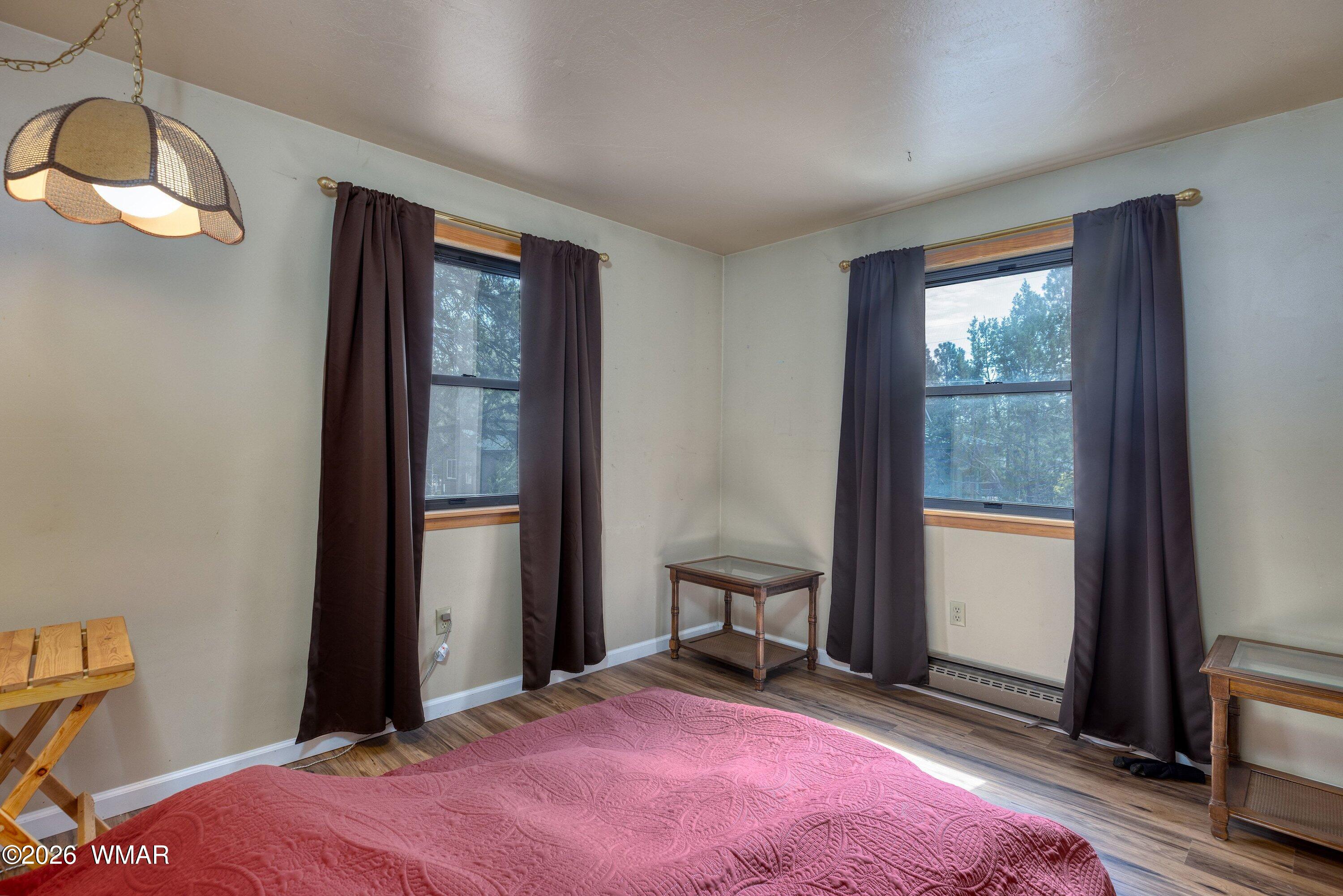 3307 Pine Ridge Drive Overgaard, AZ 85933 - Photo 10 of 24 a bedroom with a bed and a window