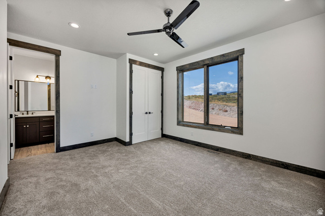 300 Knoll Loop, Unit 227 Fish Haven, ID 83287 - Photo 15 of 56 Unfurnished bedroom featuring light carpet, a ceiling fan, a closet, recessed lighting, and ensuite bathroom