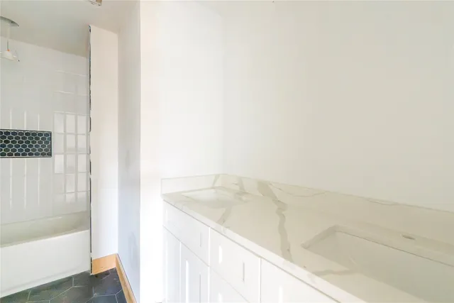 a bathroom with a bathtub and shower