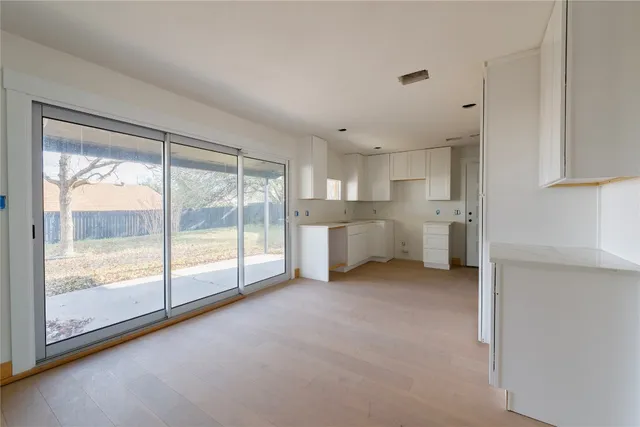a view of a kitchen with a sink and dishwasher cabinets