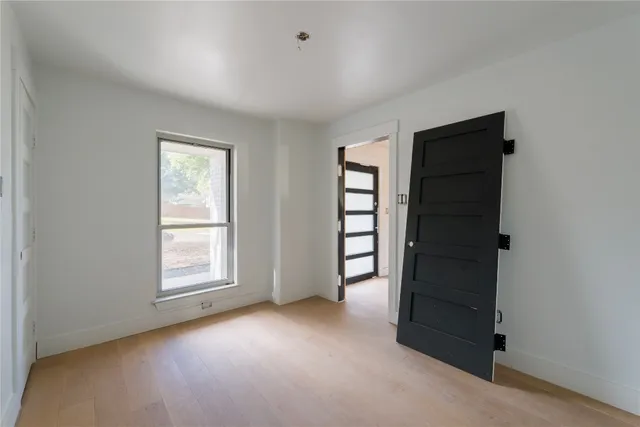 an empty room with windows and closet