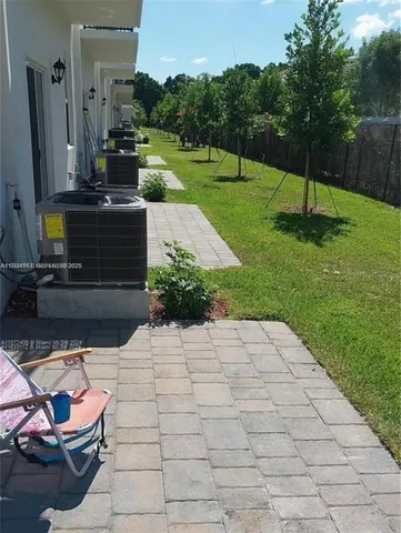 a view of a backyard with sitting area