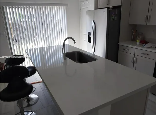 a kitchen with a refrigerator and a stove