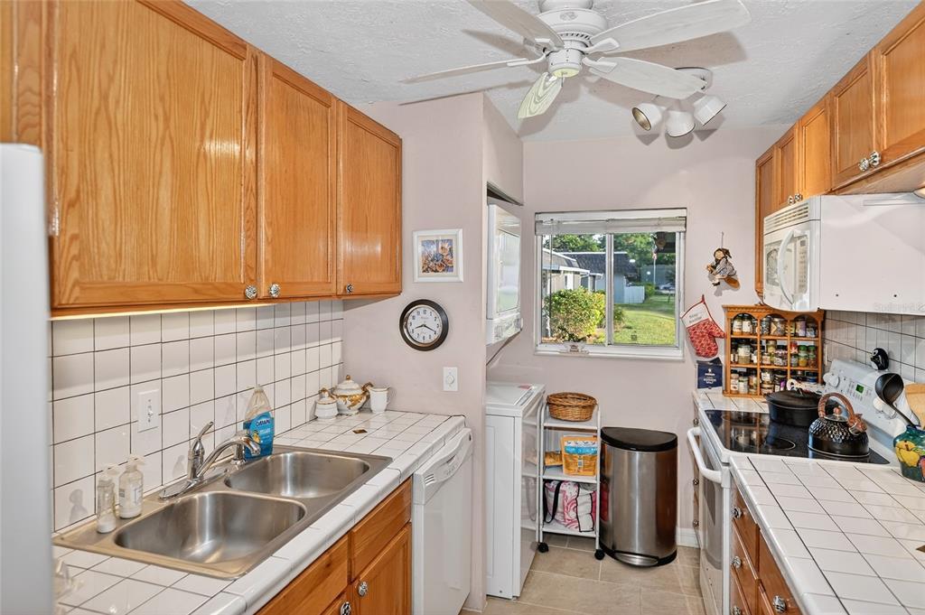 4160 Fruitville Road, Unit 11 Sarasota, FL 34232 - Photo 13 of 63 a kitchen with stainless steel appliances granite countertop a sink and stove top oven