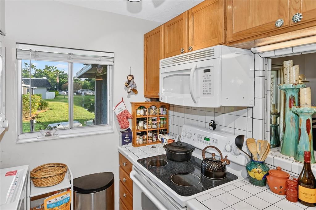 4160 Fruitville Road, Unit 11 Sarasota, FL 34232 - Photo 14 of 63 a kitchen with a stove a sink and a wooden cabinets