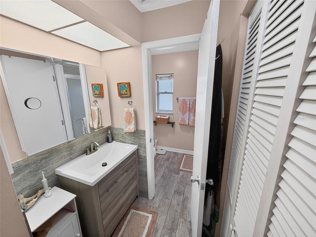 4160 Fruitville Road, Unit 11 Sarasota, FL 34232 - Photo 21 of 63 a bathroom with a sink a mirror and a shower