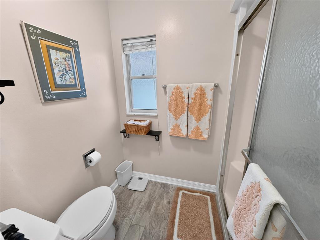 4160 Fruitville Road, Unit 11 Sarasota, FL 34232 - Photo 23 of 63 a bathroom with a toilet and a shower curtain