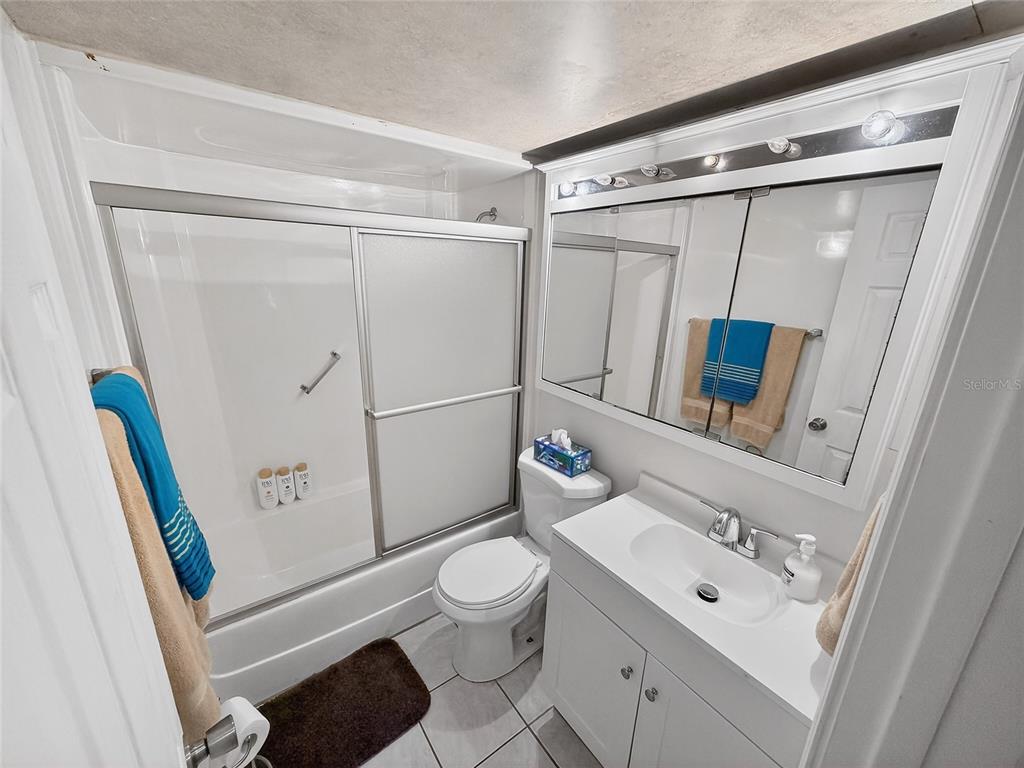 4160 Fruitville Road, Unit 11 Sarasota, FL 34232 - Photo 27 of 63 a bathroom with a granite countertop sink toilet and shower