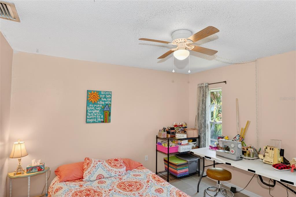 4160 Fruitville Road, Unit 11 Sarasota, FL 34232 - Photo 29 of 63 a bedroom with furniture a chandelier fan and a window