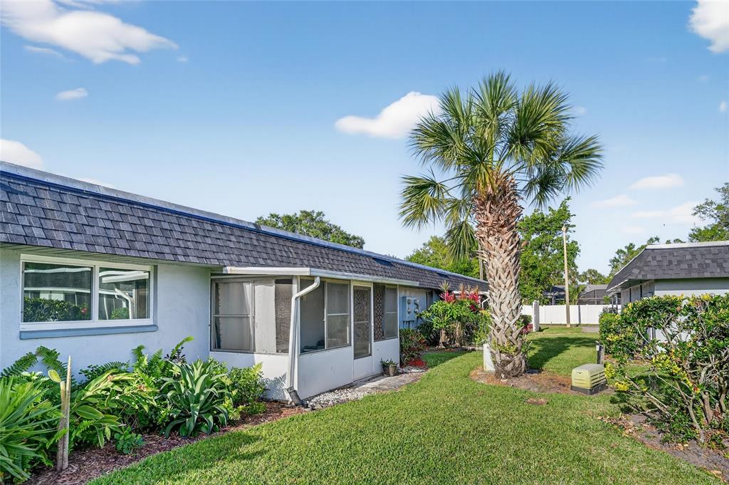 4160 Fruitville Road, Unit 11 Sarasota, FL 34232 - Photo 37 of 63 a front view of a house with a yard and potted plants