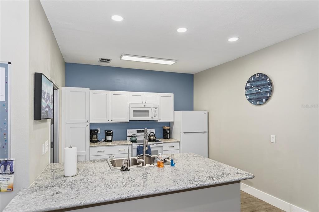 4160 Fruitville Road, Unit 11 Sarasota, FL 34232 - Photo 51 of 63 a kitchen with kitchen island a counter top space cabinets and stainless steel appliances