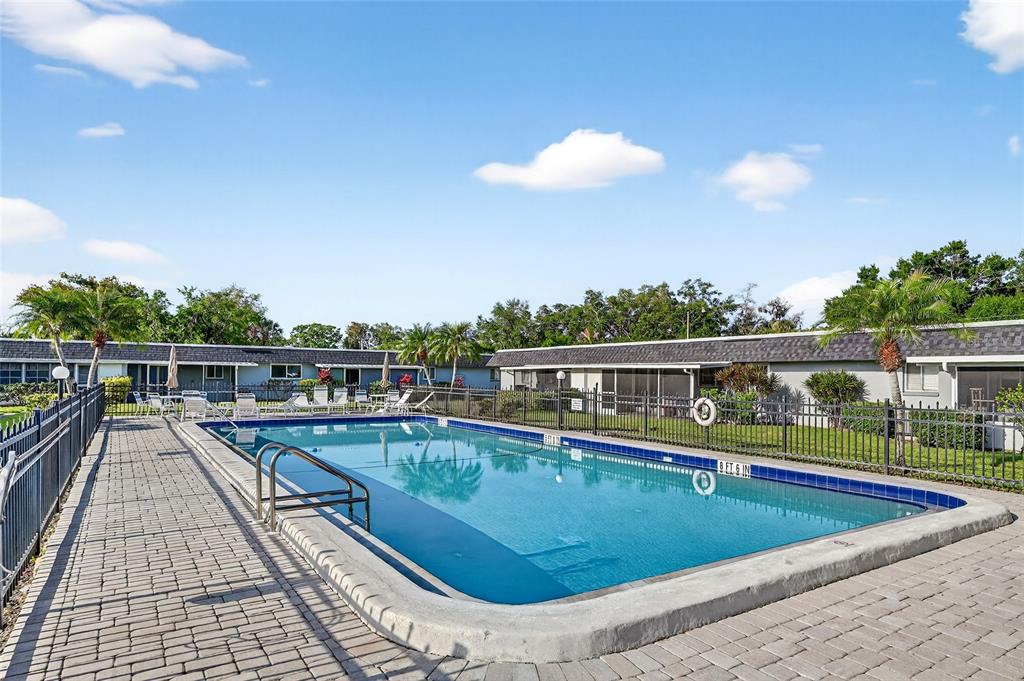 4160 Fruitville Road, Unit 11 Sarasota, FL 34232 - Photo 60 of 63 a view of a swimming pool with a lounge chairs