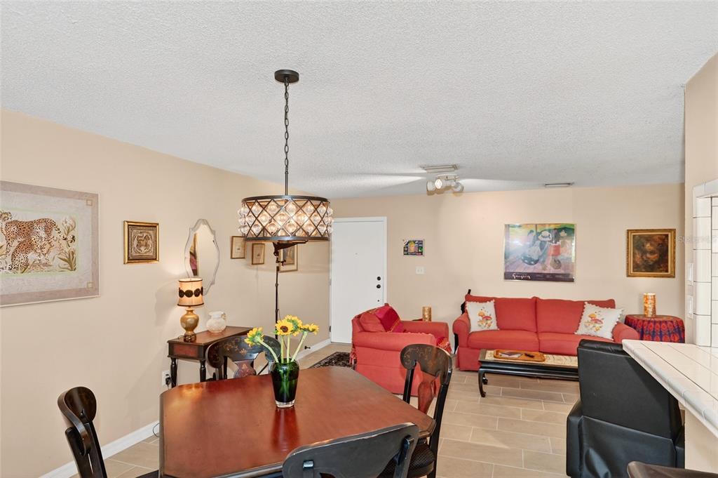 4160 Fruitville Road, Unit 11 Sarasota, FL 34232 - Photo 7 of 63 a living room with furniture and a chandelier