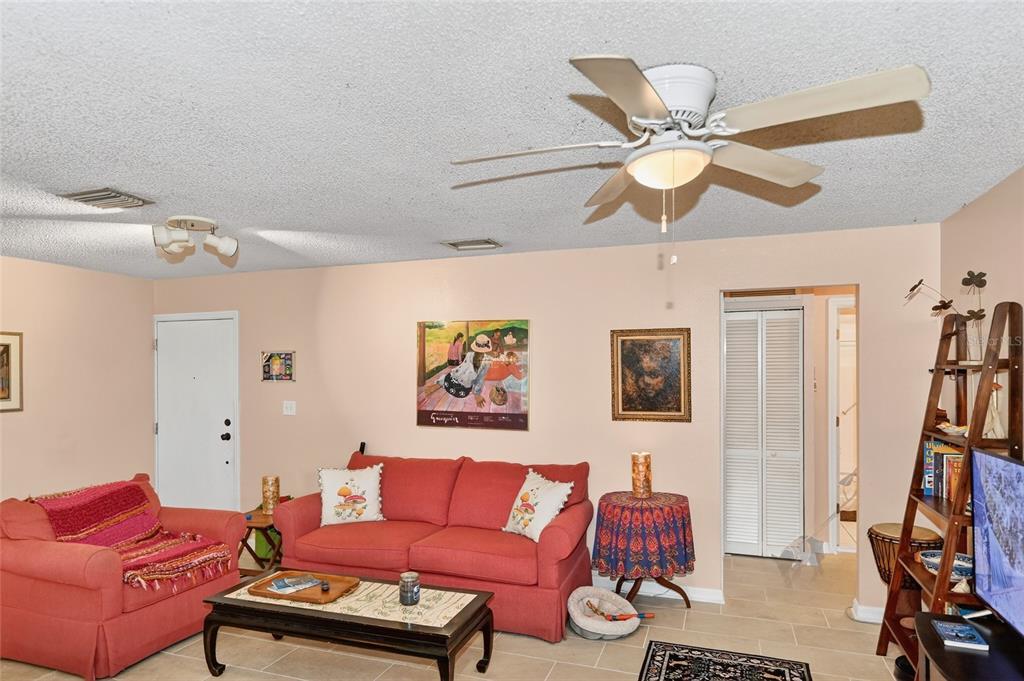 4160 Fruitville Road, Unit 11 Sarasota, FL 34232 - Photo 10 of 63 a living room with furniture a flat screen tv and a book shelf