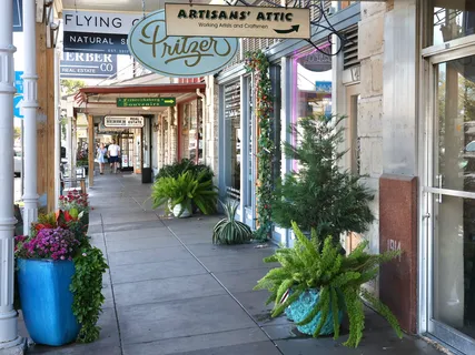 a front view of a building with potted plants