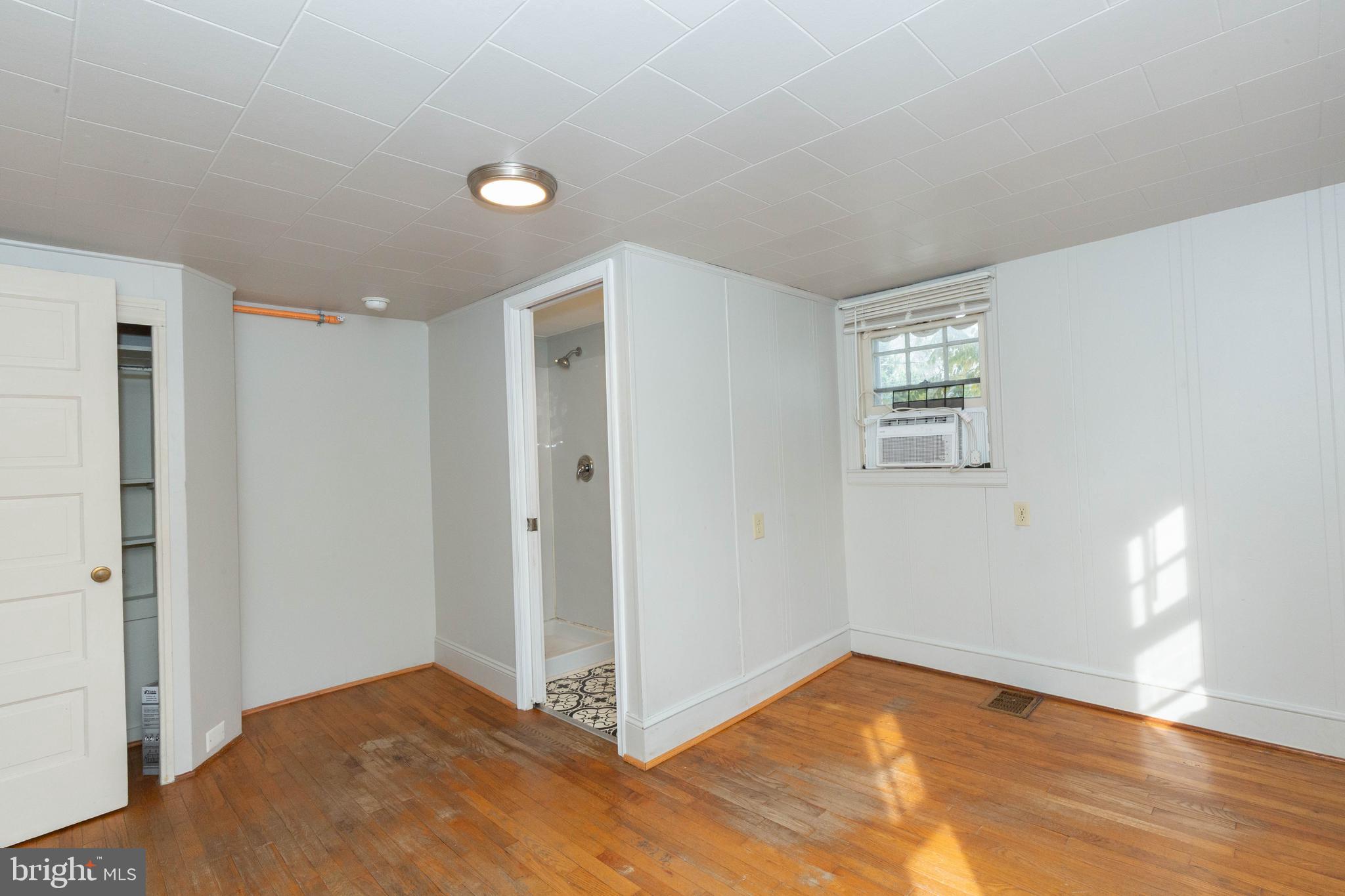 326 East Liberty Street, Unit 6 Charles Town, WV 25414 - Photo 14 of 17 a view of an empty room and window and wooden floor
