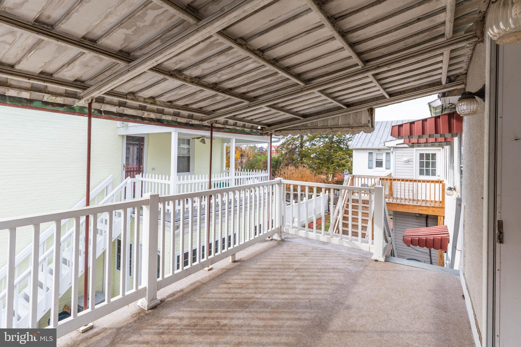 326 East Liberty Street, Unit 6 Charles Town, WV 25414 - Photo 2 of 17 a view of a porch with wooden fence