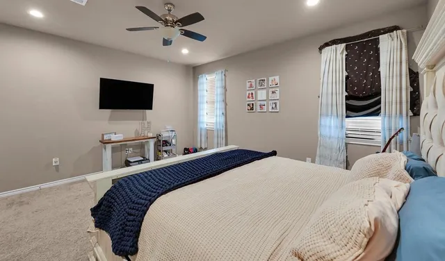 a bedroom with a bed and a flat screen tv