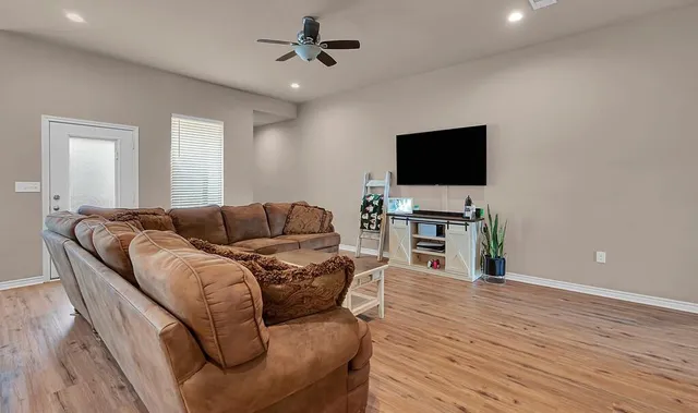 a living room with furniture and a flat screen tv