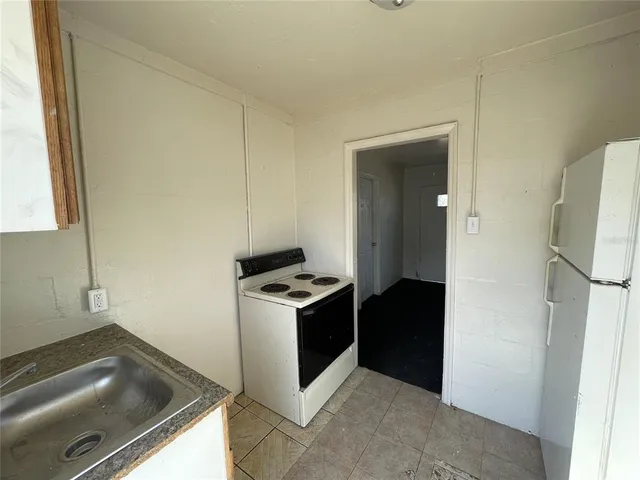 a kitchen with a stove and a refrigerator
