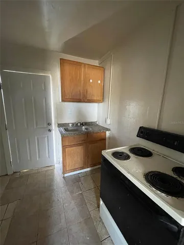 a kitchen with a stove and a refrigerator