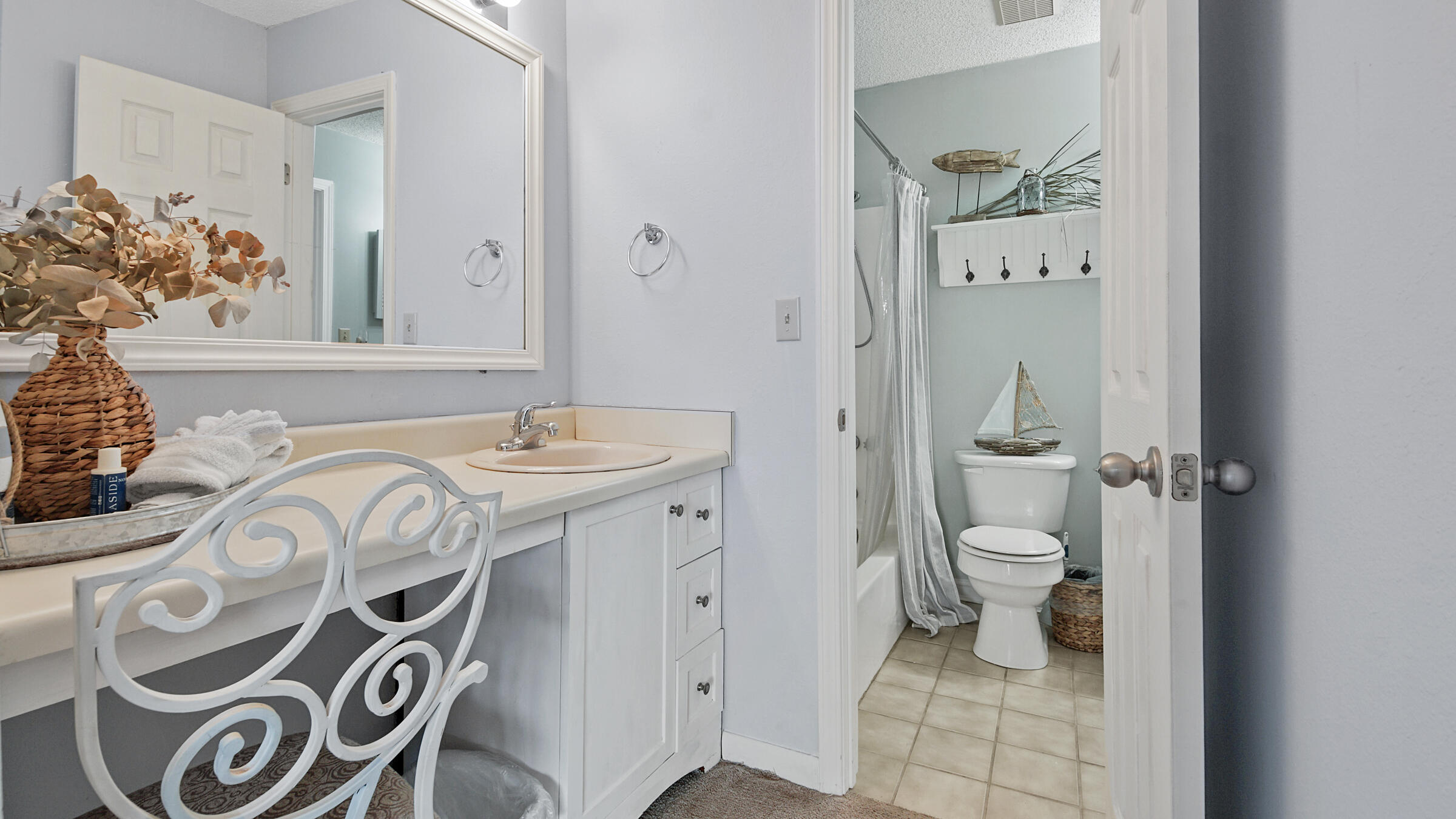 17620 Front Beach Road, Unit 2SC Panama City Beach, FL 32413 - Photo 14 of 20 a bathroom with a toilet sink and mirror