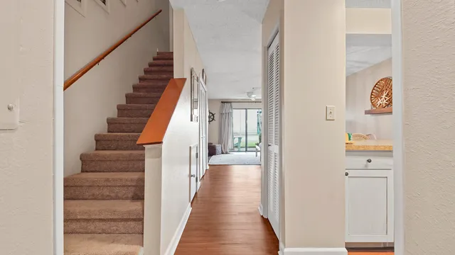 a view of a hallway with wooden floor and entryway