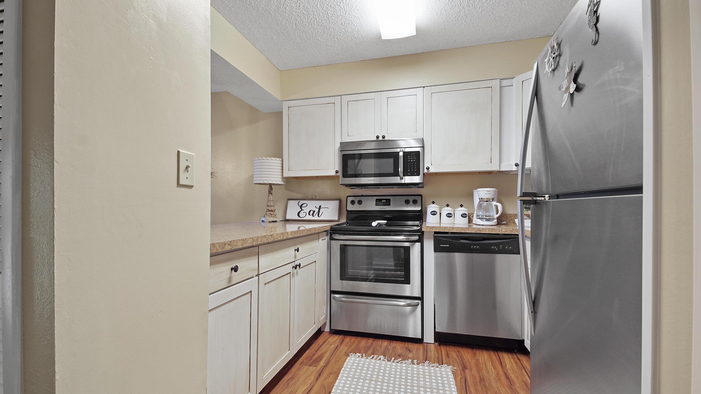 17620 Front Beach Road, Unit 2SC Panama City Beach, FL 32413 - Photo 7 of 20 a kitchen with cabinets stainless steel appliances and a counter space