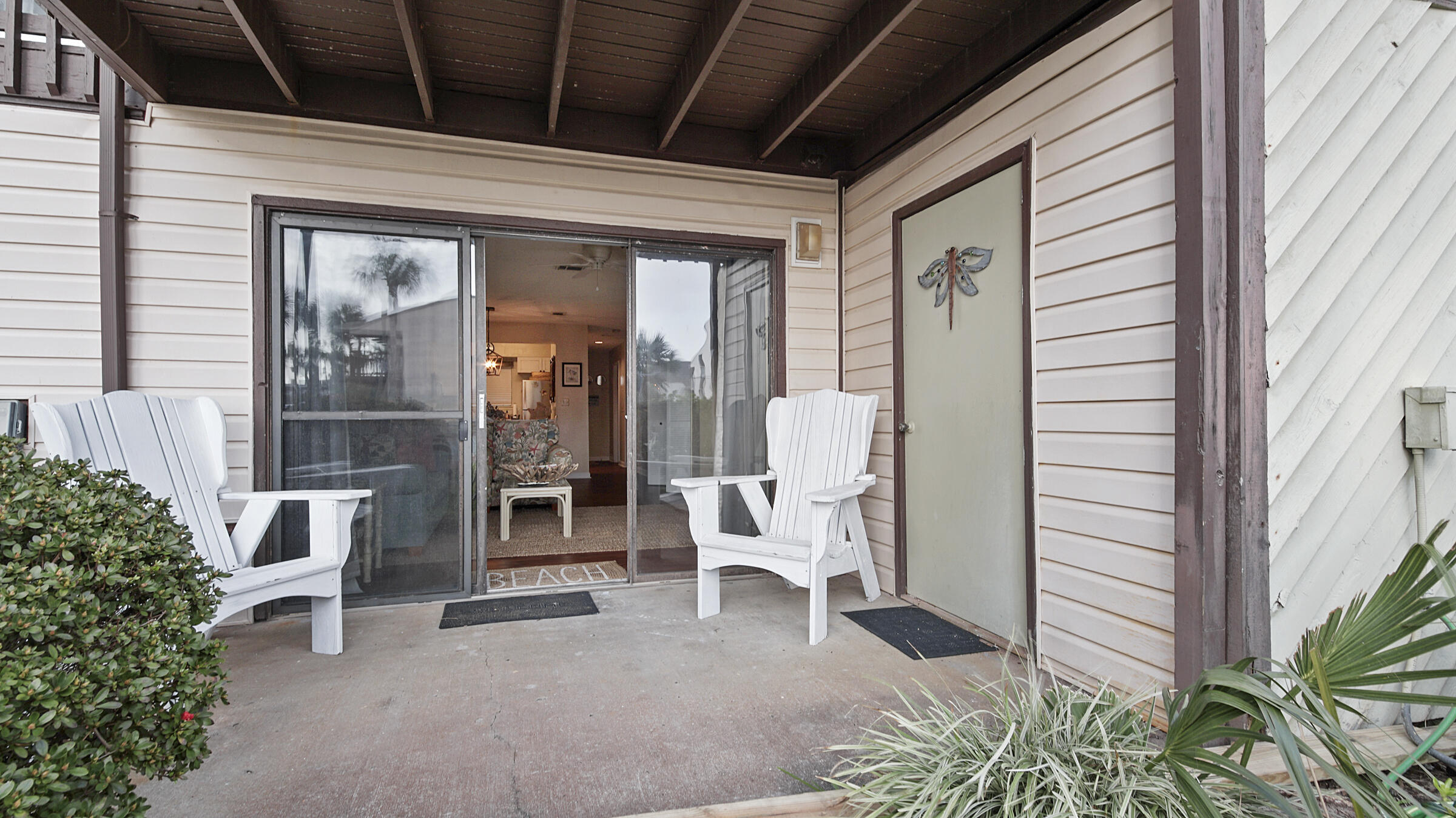 17620 Front Beach Road, Unit 2SC Panama City Beach, FL 32413 - Photo 10 of 20 a view of a porch with a table and chairs and potted plants