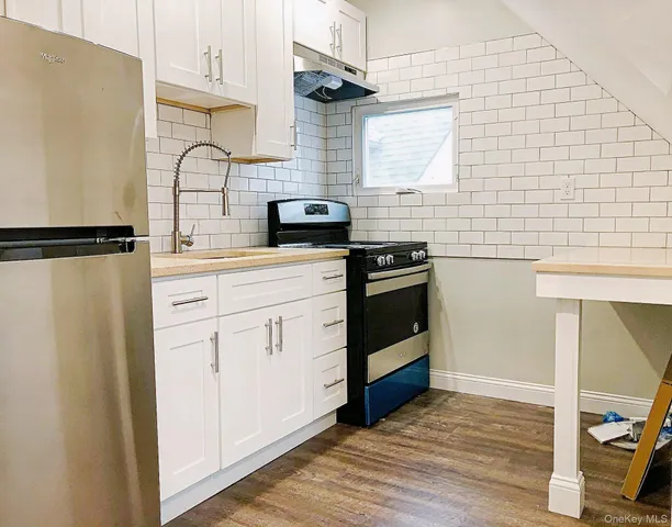 a kitchen with stainless steel appliances a refrigerator stove and sink
