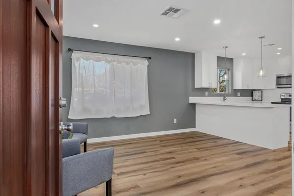 a room with a couch and a view of kitchen