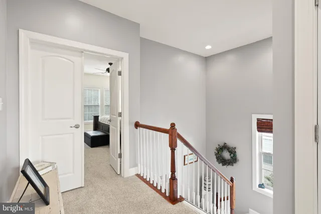 a view of a hallway with a livingroom and entryway