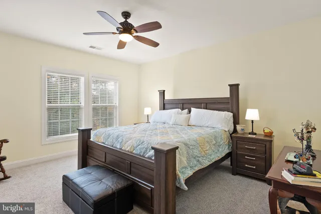 a bed sitting in a bedroom next to a window