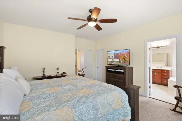 a bedroom with a bed and a television