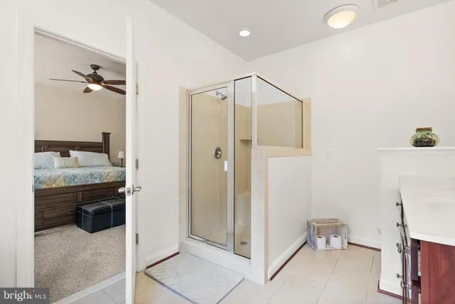 a bathroom with a granite countertop sink a toilet and shower