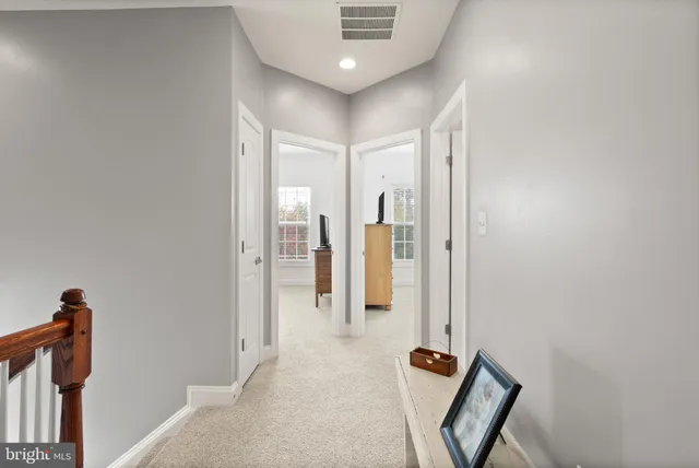 a view of a hallway with paintings on the wall