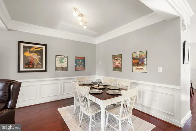a kitchen with stainless steel appliances kitchen island a table and chairs in it